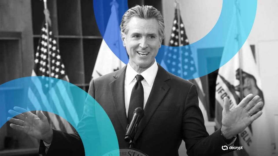 California Governor Gavin Newsom signing legislation at a desk with officials standing behind him